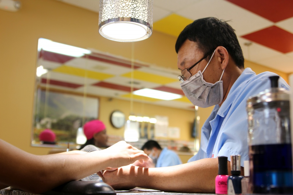 Cong Nguyen, owner and nail technician, works on a Magic Nails customer. (Photo by Marlowe Starling)
